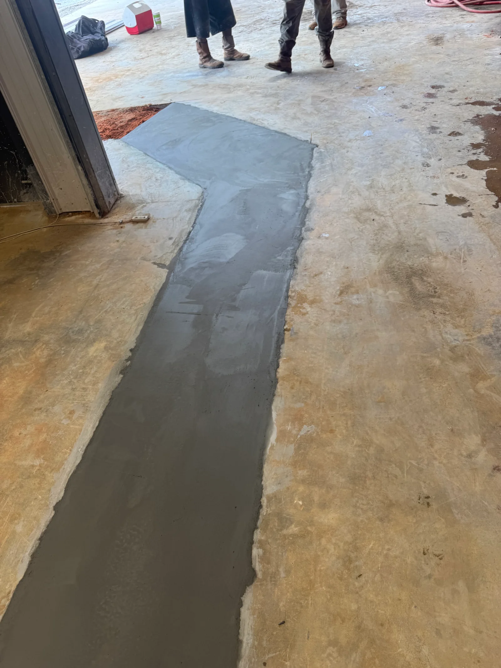 Freshly poured concrete walkway with smooth finish and clean edges on construction site